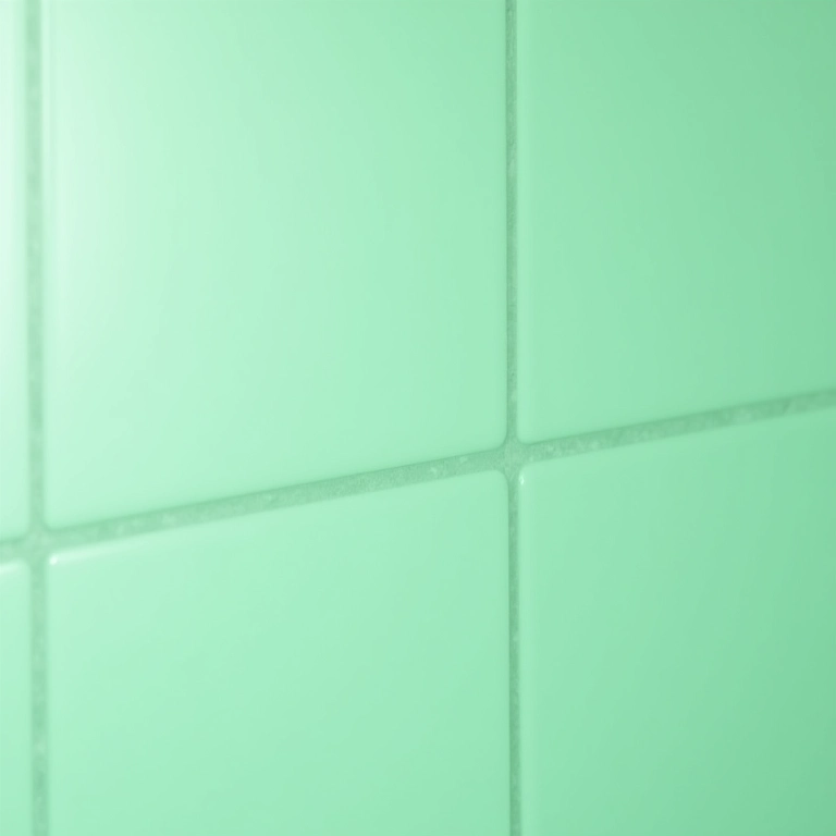 Detalhe de azulejos verde claro em um banheiro moderno.